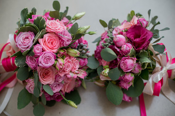 wedding bridal bouquet with pink flowers lying on the bed
