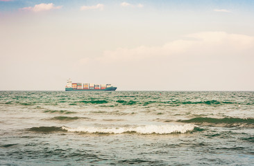 Obraz premium Beautiful seascape with cargo ship from coast of Catania, Sicily, Italy