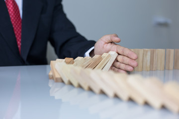 Stopping the domino effect concept for business solution, strategy and successful intervention