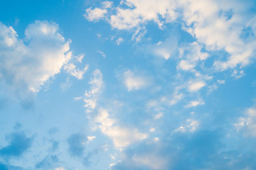 Blue sky with clouds background.