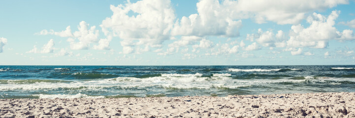 calming view of sea side with sand and clouds on blue sky panorama