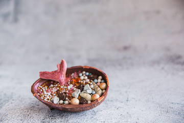 Half a chocolate egg filled with popped rice. The egg is decorated with precious stones and a mermaids tail