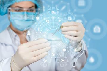 A laboratorian assistant is operating with a pipette and a sample on the glass.