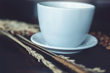 black Coffee cup and coffee bean on wood desk at coffee shop - vintage  effect.
