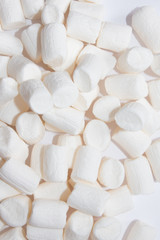 Fototapeta na wymiar Top view of Fluffy white marshmallow isolated on white background. Sweet food. Background or texture of mini marshmallows. Close-up. Marshmallows food background.