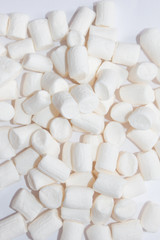 Top view of Fluffy white marshmallow  isolated on white background. Sweet food. Background or texture of  mini marshmallows. Close-up. Marshmallows food background.