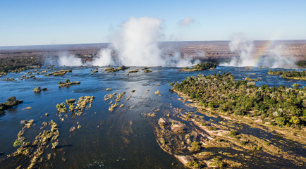 The Victoria falls is the largest curtain of water in the world. The falls and the surrounding area is the Mosi-oa-Tunya National Parks and World Heritage Site (helicopter view) - Zambia, Zimbabwe. Af