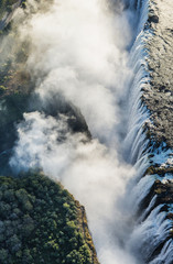 The Victoria falls is the largest curtain of water in the world. The falls and the surrounding area is the Mosi-oa-Tunya National Parks and World Heritage Site (helicopter view) - Zambia, Zimbabwe. Af