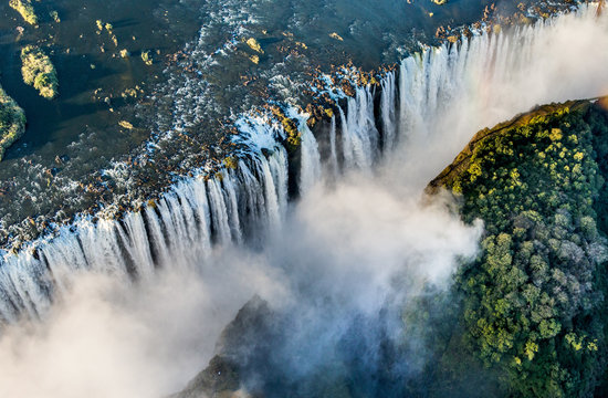 The Victoria falls is the largest curtain of water in the world. The falls and the surrounding area is the Mosi-oa-Tunya National Parks and World Heritage Site (helicopter view) - Zambia, Zimbabwe. Af