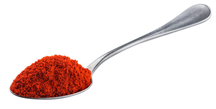 Pile of red paprika powder in spoon isolated on white background with clipping path, ground red pepper spice