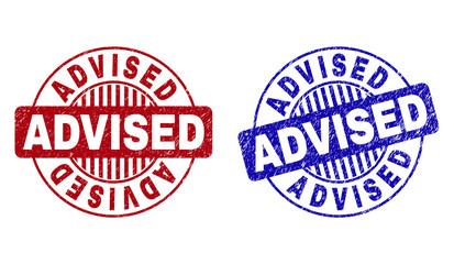 Grunge ADVISED round stamp seals isolated on a white background. Round seals with grunge texture in red and blue colors. Vector rubber overlay of ADVISED title inside circle form with stripes.