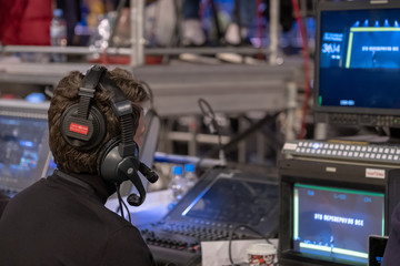 Video broadcast operator workis at business conference