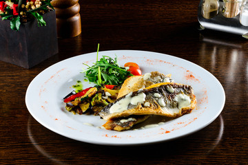 Baked seabass with Greek salad