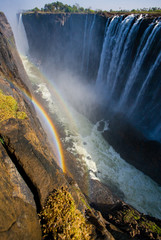 Victoria Falls. A general view with a rainbow. National park. Mosi-oa-Tunya National park. and World Heritage Site. Africa. Zambiya. Zimbabwe. 
