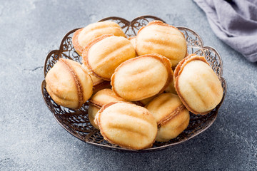 Homemade Russian cookies with boiled condensed milk on a dark background.
