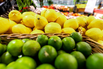 Lime and lemons background. Fresh organic lemons and lime on a local farmer food market on Bali island.