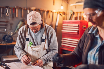 Couple working together in a retro vintage garage.