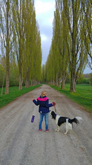 girl with dog at parkway in nature