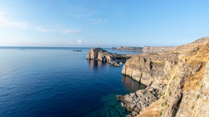 Fototapeta na wymiar Rocky cliffs of the island of Rhodes
