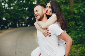 Beautiful couple spend time in a summer park