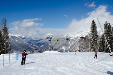 Skiers on the top of the Caucasus mountains in the ski resort Krasnaya Polyana Russia