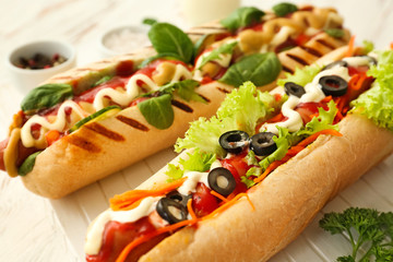 Tasty hot dogs on table