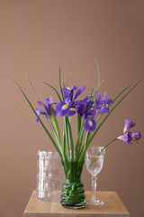 Vases with beautiful flowers on table