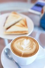 hot latte coffee drink and sandwich put on table breakfast in the morning day