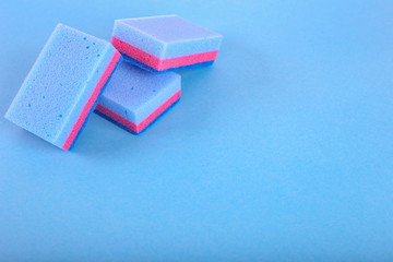 Cleaning sponges on a blue background. With copy space for text.