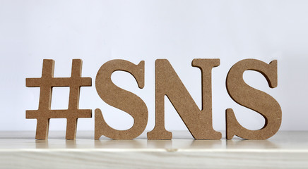Wooden blocks of #SNS text.