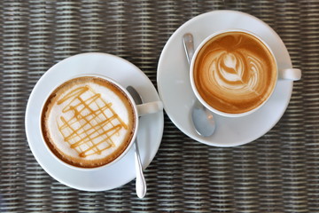 hot caramel macchiato and latte coffee drink put on table in cafe