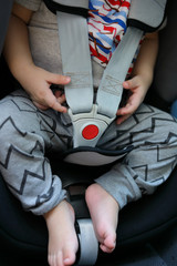 baby sitting in car seat with life safety belt lock protection