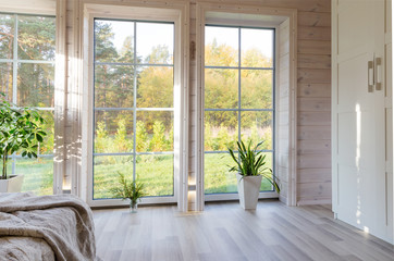 Bright interior, room in wooden house with large window. Scandinavian style.