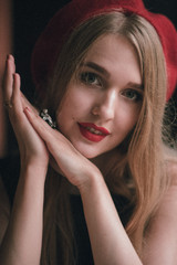 Closeup portrait of a young beautiful woman in beret