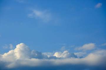 sunlight through fluffy white cloud on clear blue sky background