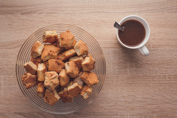 Mug with hot cocoa and a bowl of delicious cinnamon cookies. Delicious afternoon snack