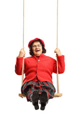 Elderly cheerful lady on a swing