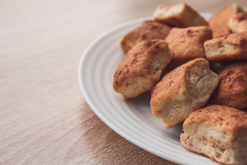 Fresh homemade pastries in a plate lit with soft daylight. Palatable cookies