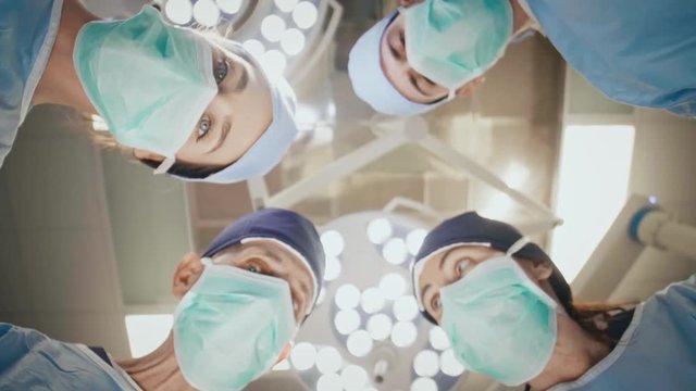 Group of surgeons having a conversation over the operating table 