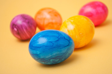 Fototapeta na wymiar closeup of decorative painted easter eggs on yellow background