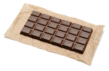 milk chocolate bar on craft packaging paper isolated on white background with clipping path