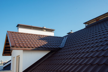 Tile Roof of a two-story white cottage