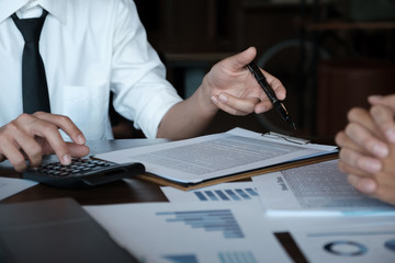 Fototapeta premium Economic research discussions, Business team analyzing income charts and graphs to plan marketing concept with using calculator for analysis.