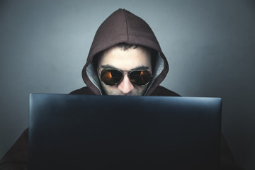 Hacker with laptop. Computer crime