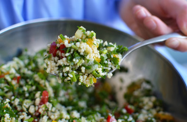 Close up shot of fork over salad bowl