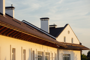 Tile Roof of a two-story white cottage