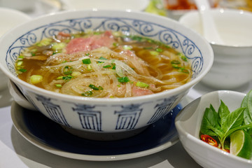 Rice pasta with sliced raw beef in veal (vietnamese pho Beef Noodle Soup)