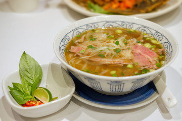 Rice pasta with sliced raw beef in veal (vietnamese pho Beef Noodle Soup)