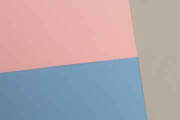 Multicolor background from cardboard of different colors. Pastel paper color for background. Colorful abstract geometric shapes. Pastel colored paper texture minimalism background. Pink, Blue, Grey.