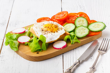Breakfast - bread toast with poached egg, spices and arugula